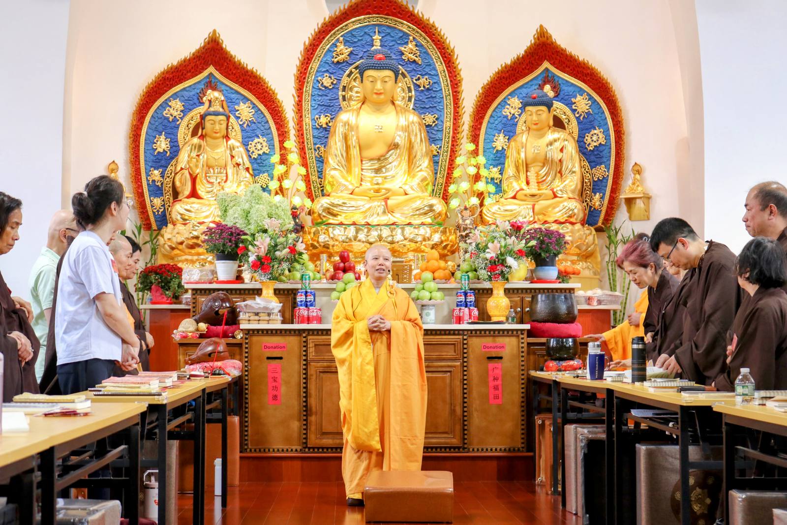 The founder speaking before the three Buddhas in the main shrine hall